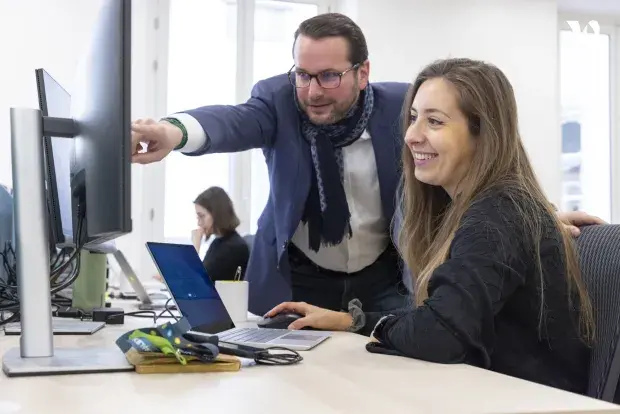 Deux collaborateurs regardant un écran